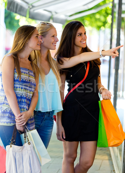Group of beautiful girls looking at the shop window.  Stock photo © nenetus