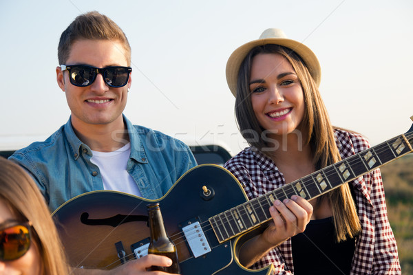 Stock photo: Portrait of group of friends playing guitar and drinking beer.