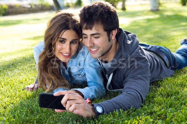 happy young couple with smartphone at the park Stock photo © nenetus