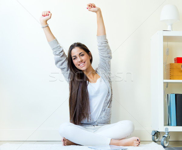 Beautiful young woman waking up and stretching arms at home.  Stock photo © nenetus