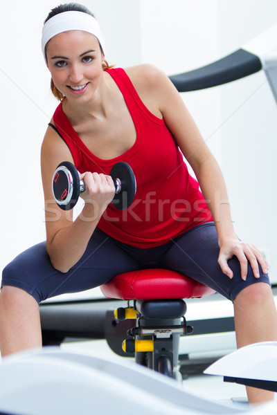 Happy young woman practicing sport in gym Stock photo © nenetus
