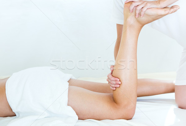 Masseur doing massage on man body in the spa salon. Stock photo © nenetus