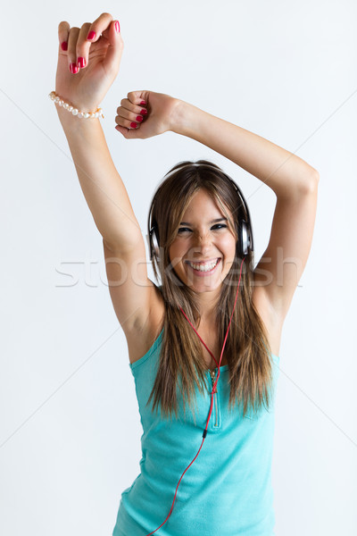 Beautiful girl dancing and listening to music. Isolated on white Stock photo © nenetus