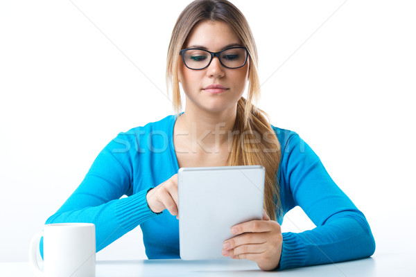 Young smiling woman using digital tablet. Isolated on white. Stock photo © nenetus