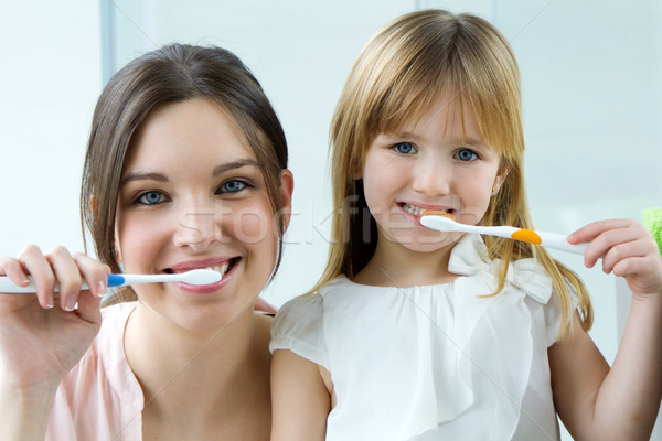 Mother and daughter brushing teeth in the bathroom Stock photo © nenetus