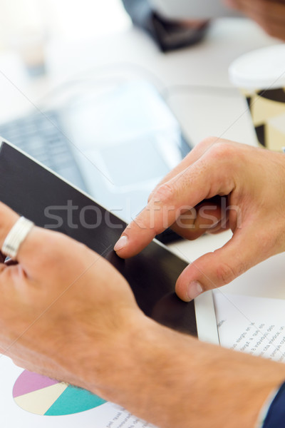 Businessman finger pointing to the screen of a digital tablet. Stock photo © nenetus