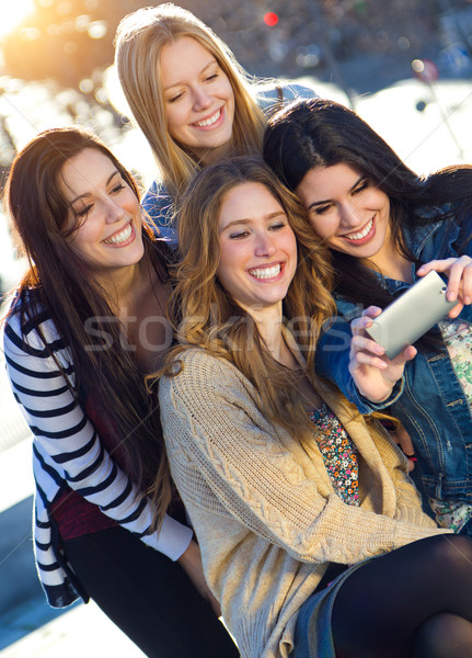 A group of friends taking photos with a smartphone Stock photo © nenetus