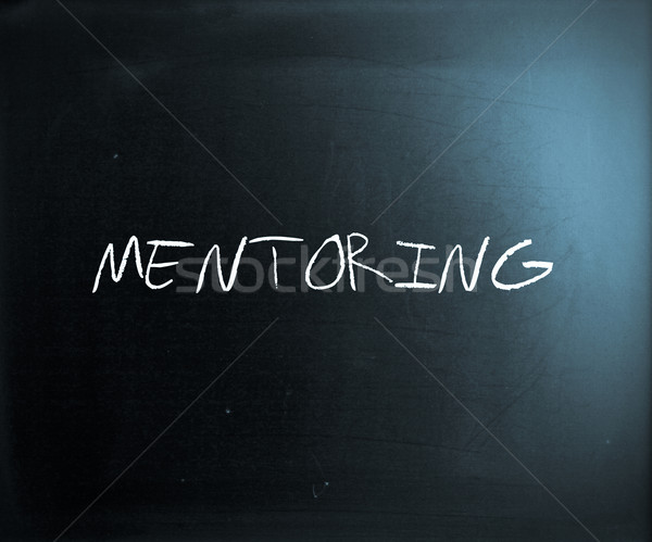 'Mentoring' handwritten with white chalk on a blackboard Stock photo © nenovbrothers