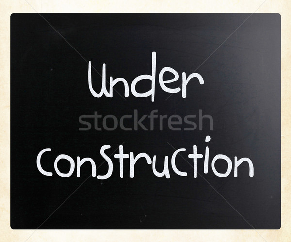 'Under construction' handwritten with white chalk on a blackboar Stock photo © nenovbrothers
