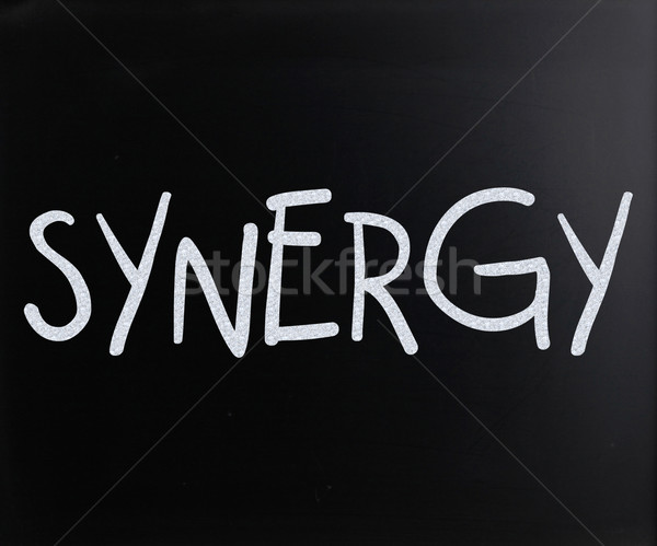 The word 'Synergy' handwritten with white chalk on a blackboard Stock photo © nenovbrothers