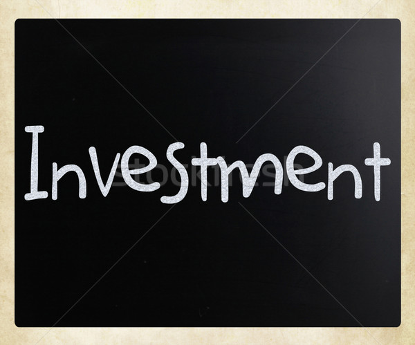 The word 'Investment' handwritten with white chalk on a blackboa Stock photo © nenovbrothers