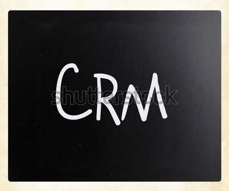 The word 'CRM' handwritten with white chalk on a blackboard Stock photo © nenovbrothers