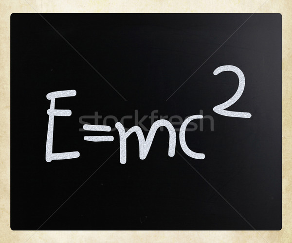 Stock photo: E=mc2 handwritten with white chalk on a blackboard