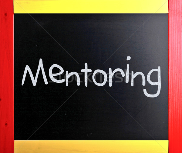 The word 'Mentoring' handwritten with white chalk on a blackboar Stock photo © nenovbrothers