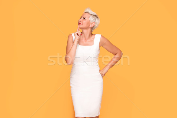 Beautiful woman posing on yellow background. Stock photo © NeonShot