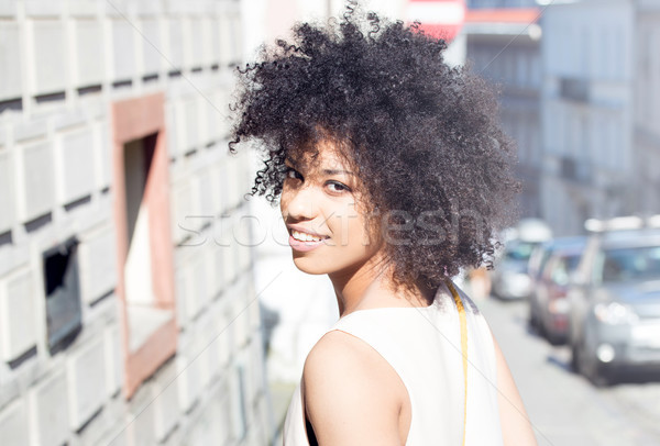 Stock photo: Girl with afro posing, smiling.