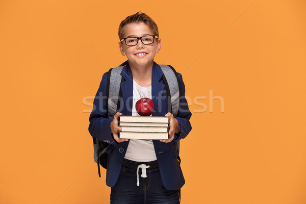 Kicsi iskolás fiú hátizsák könyvek szemüveg áll Stock fotó © NeonShot