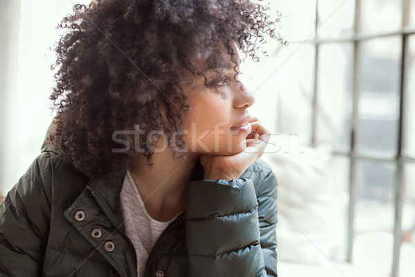 Young girl with afro using smart phone. Stock photo © NeonShot