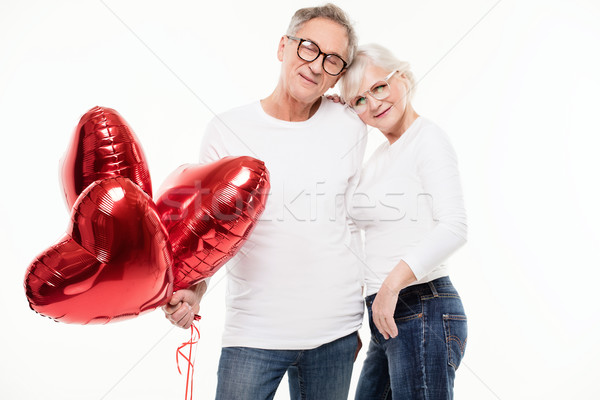 Feliz pareja de ancianos posando hermosa junto rojo Foto stock © NeonShot