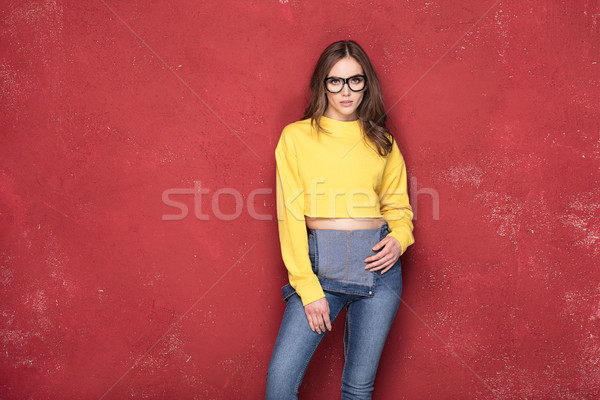 Happy girl standing on red background. Stock photo © NeonShot