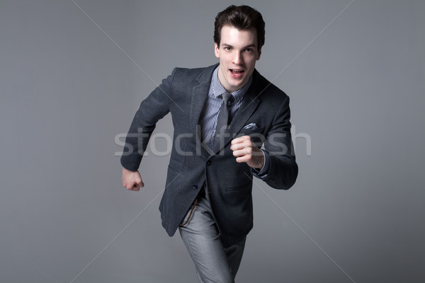 Running businessman. Studio shot. Stock photo © NeonShot