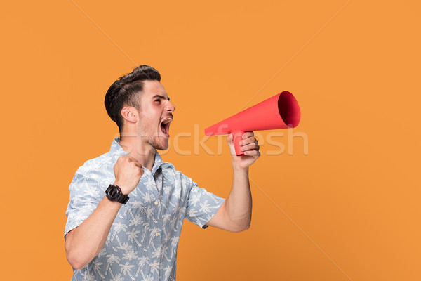 Knappe man megafoon jonge geïsoleerd oranje Stockfoto © NeonShot