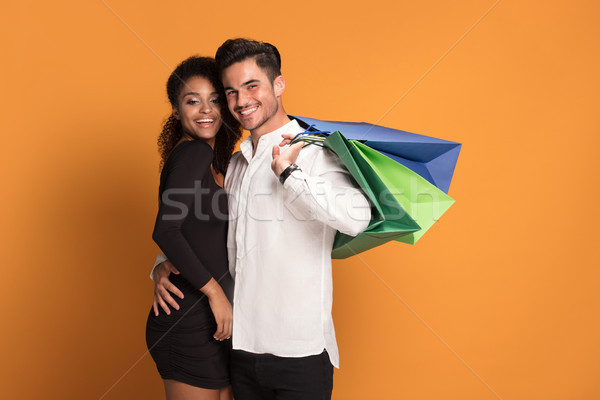 Boldog pár pózol bevásárlótáskák gyönyörű mosolyog Stock fotó © NeonShot