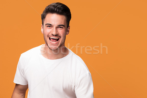 Gelukkig knappe man Geel glimlachend jonge genieten Stockfoto © NeonShot
