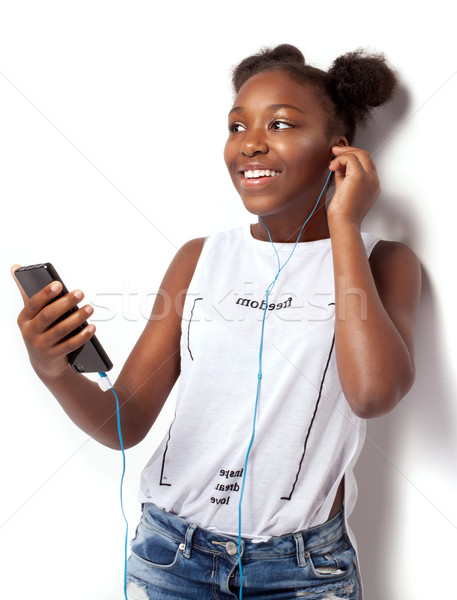 Smiling young girl listening to music. Stock photo © NeonShot