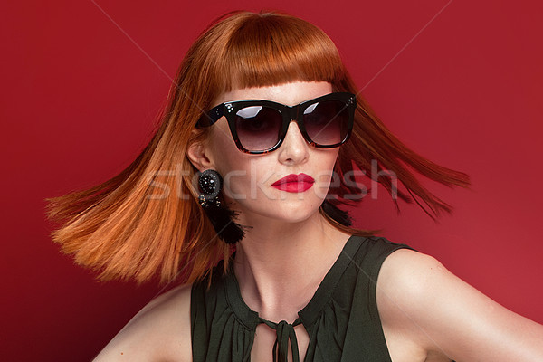 Fashionable redhead woman posing in studio. Stock photo © NeonShot