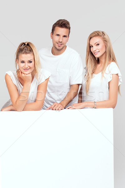 Stock photo: Group of smiling people with empty white board.
