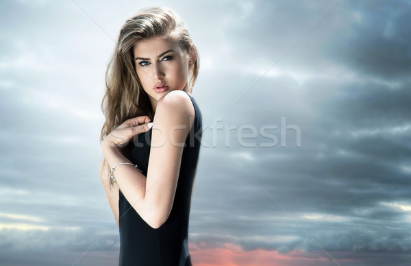 Elegant girl in black dress posing. Stock photo © NeonShot