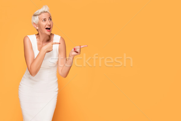 Stock photo: Beautiful woman posing on yellow background.