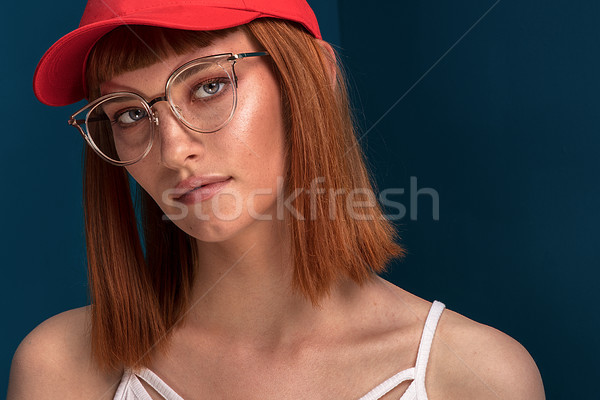 Fashionable redhead girl in red cap and eyeglasses. Stock photo © NeonShot