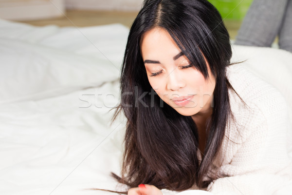Young asian woman relaxing. Stock photo © NeonShot