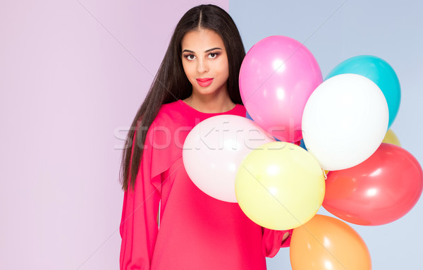 Stock photo: Happy young woman with balloons.