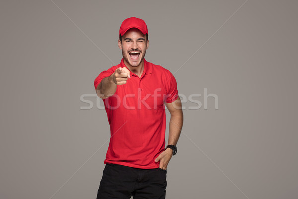 Smiling courier man posing in studio. Stock photo © NeonShot