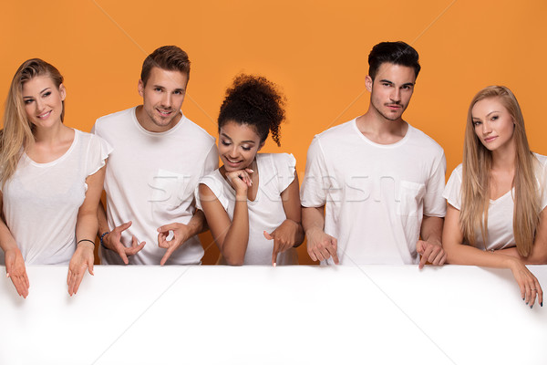 Stock photo: Five people posing with white empty board.