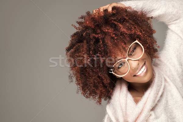 Stock photo: Happy woman with afro hairstyle smiling.