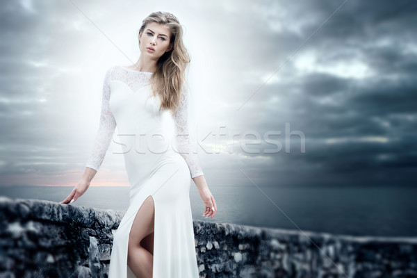 Elegant girl in white dress posing. Stock photo © NeonShot