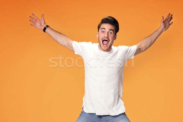 Happy handsome man jumping with big smile. Stock photo © NeonShot
