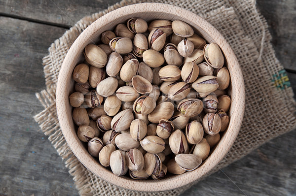  Dried Pistachio Nuts In A Wooden Bowl Stock photo © nessokv