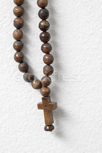rosary beads  hanging against white wall Stock photo © nessokv
