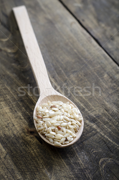 Brown rice in wooden spoon Stock photo © nessokv