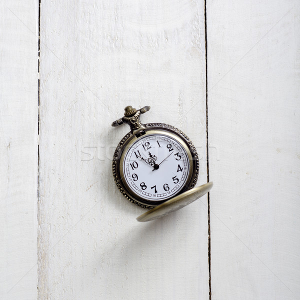 Pocket watch and chain against aged wood Stock photo © nessokv