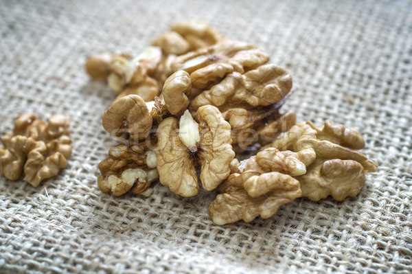 Cracked walnuts  on burlap background Stock photo © nessokv