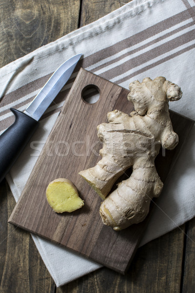 Stock photo: Fresh ginger root on a cutting board