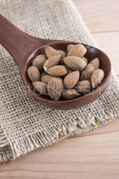 Almonds kernel in awooden spoon Stock photo © nessokv