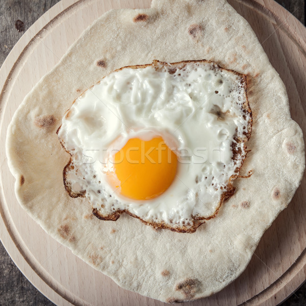 Fried egg on  grilled flour tortilla Stock photo © nessokv