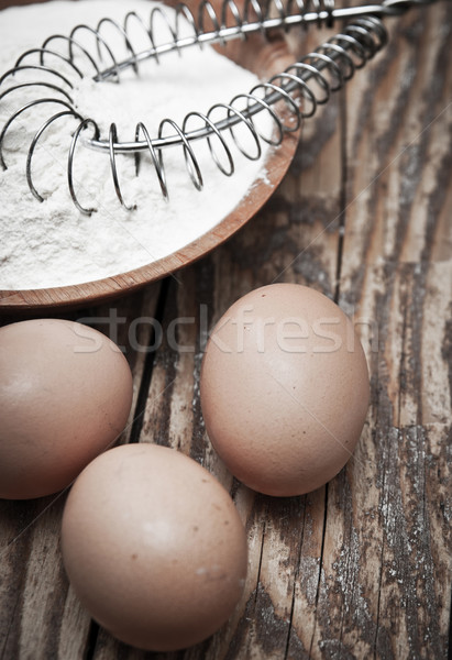Stock photo: Flour and eggs on wooden background